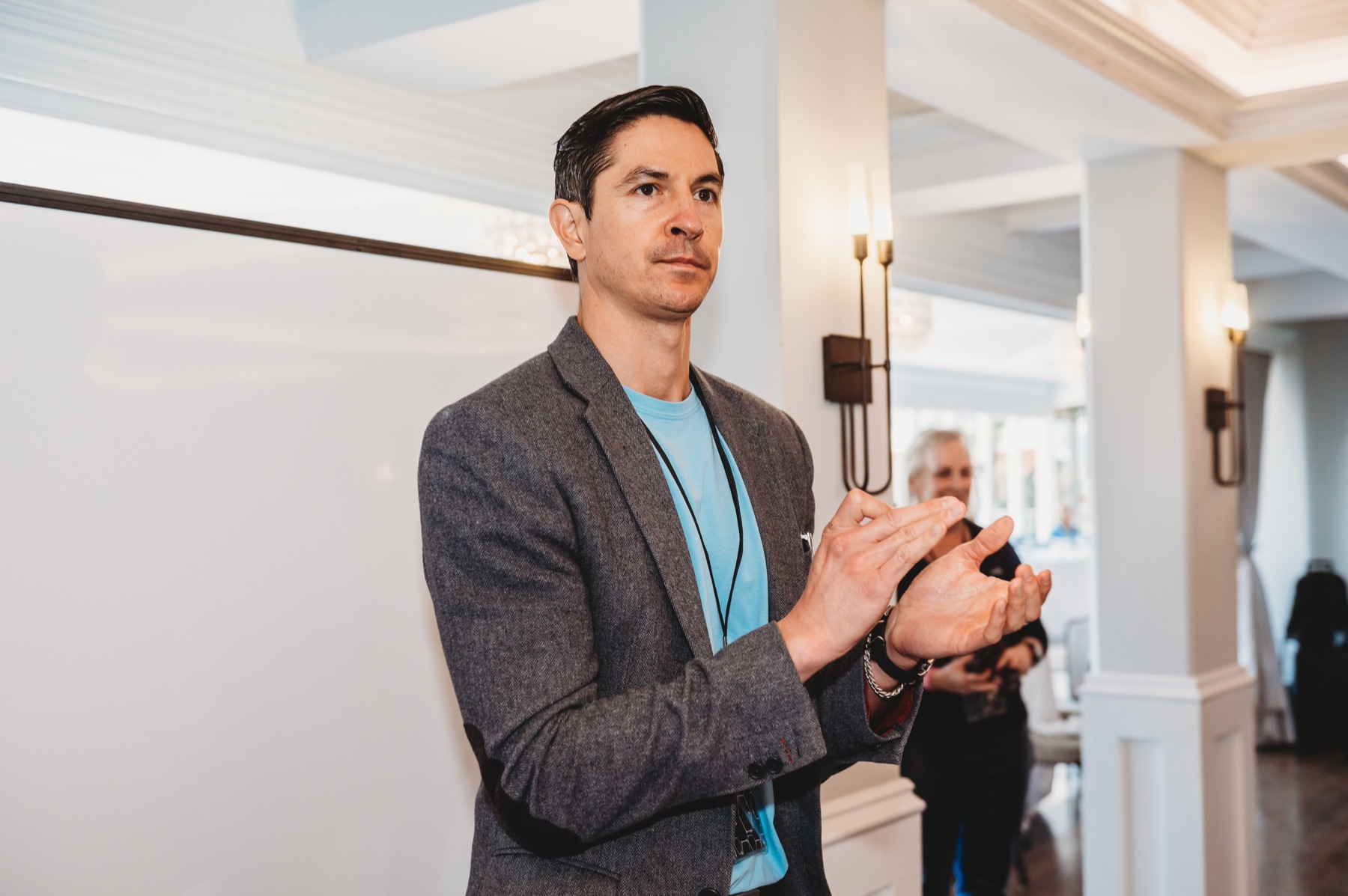 A FIRE Summit 2025 attendee applauding a session