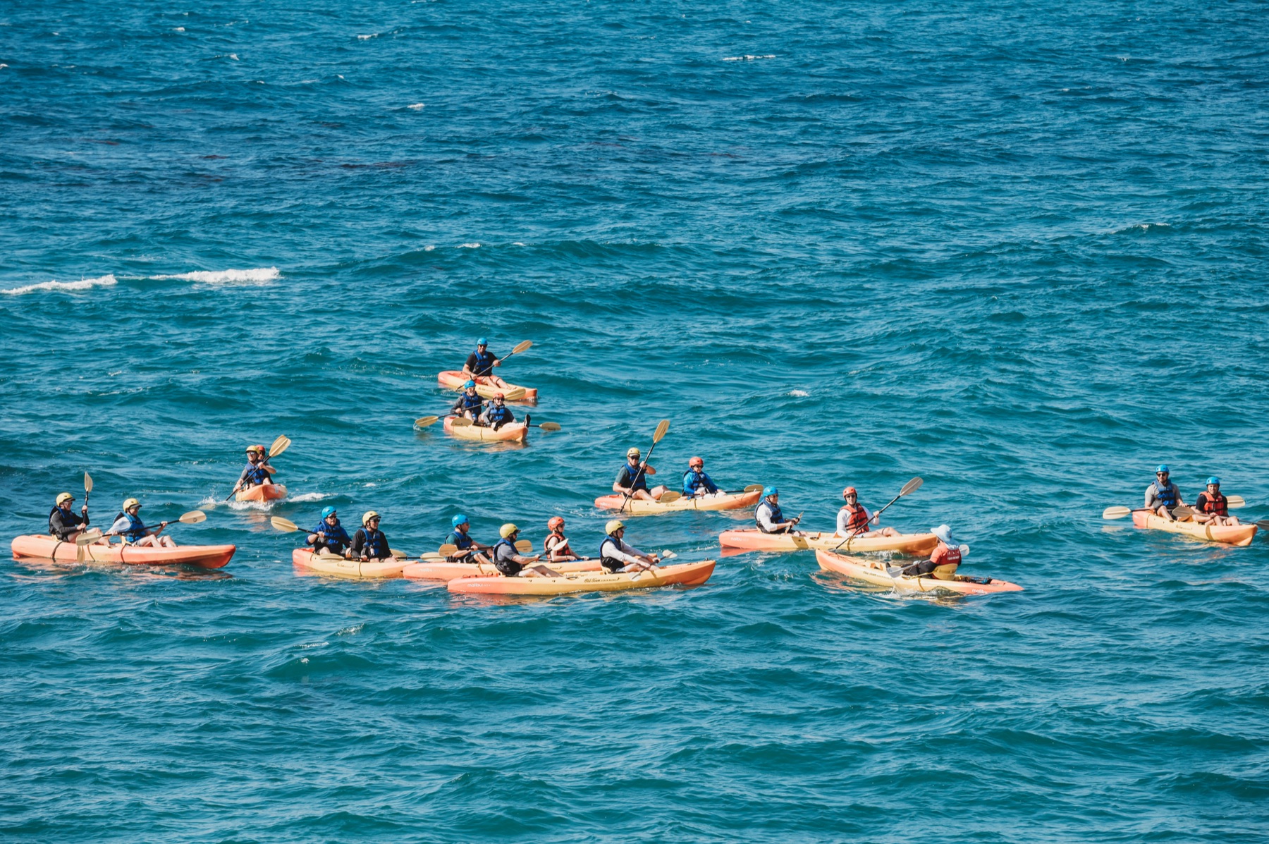 FIRE Summit 2025 attendees kayaking together in La Jolla