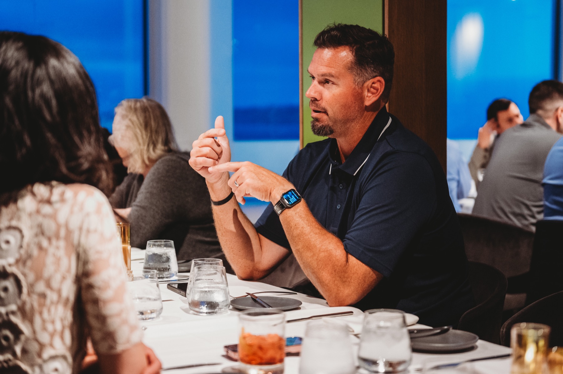 A FIRE Summit 2025 attendee sharing a point over dinner