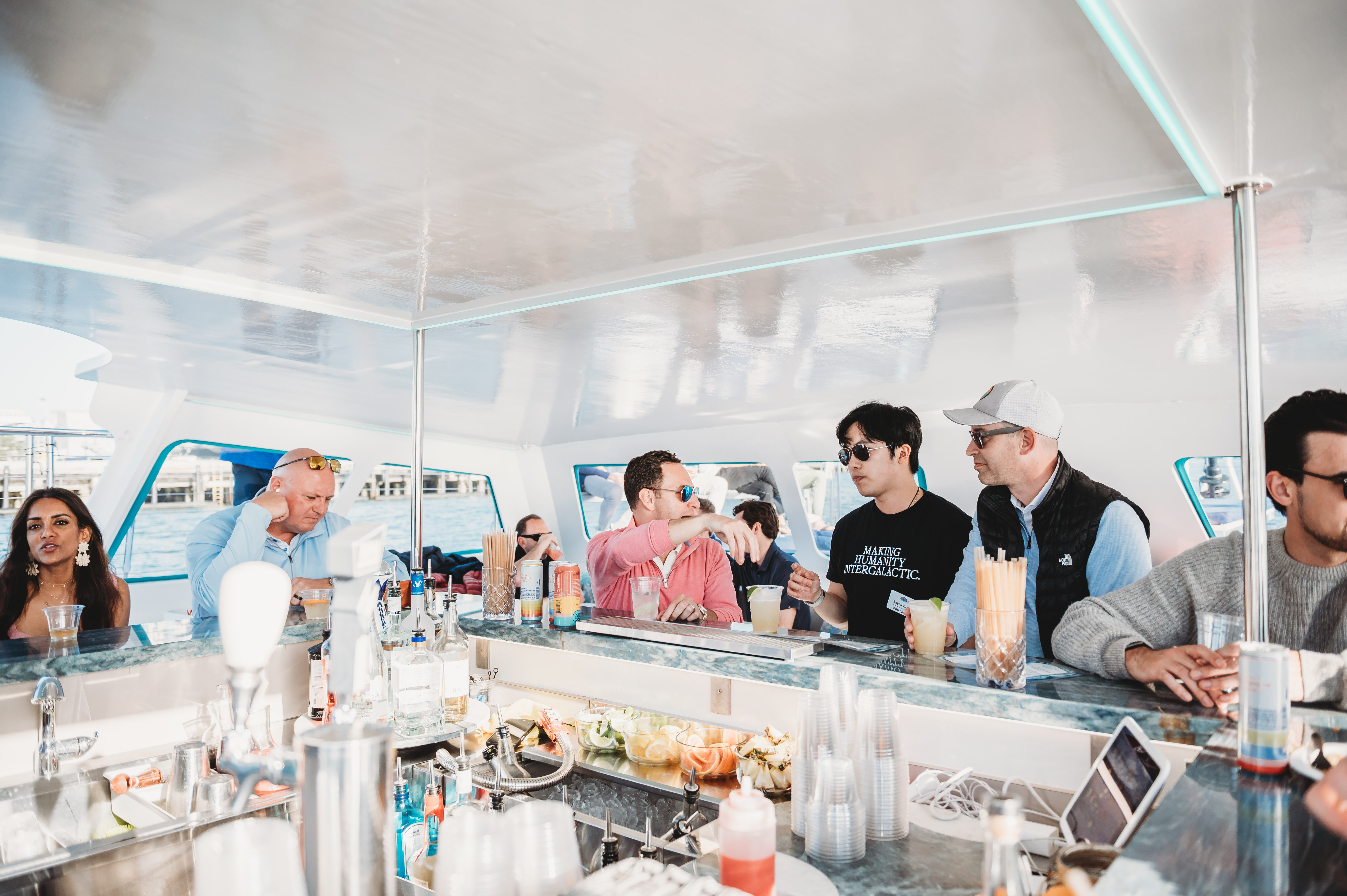 FIRE Summit 2026 attendees gathering around the bar aboard the boat