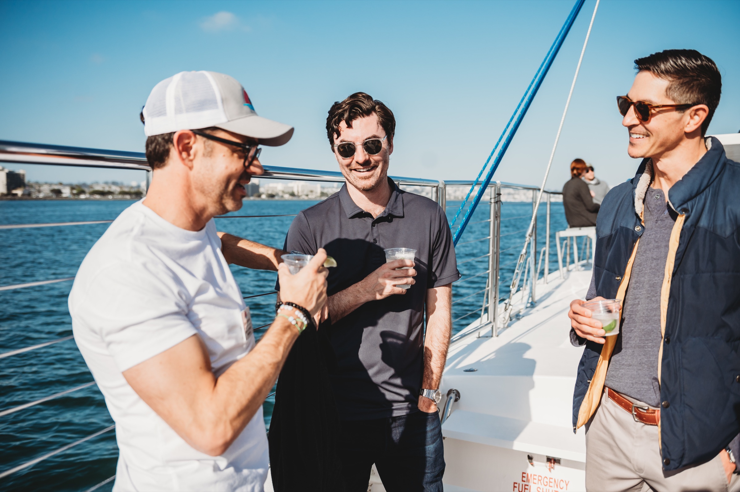 Three FIRE Summit 2026 attendees talking aboard the boat