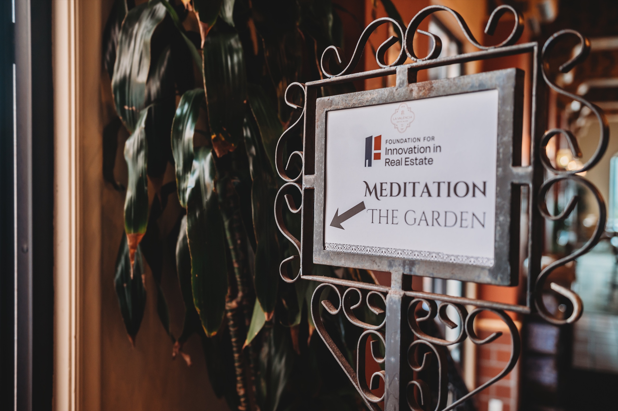 A FIRE Summit sign pointing to meditation in the garden