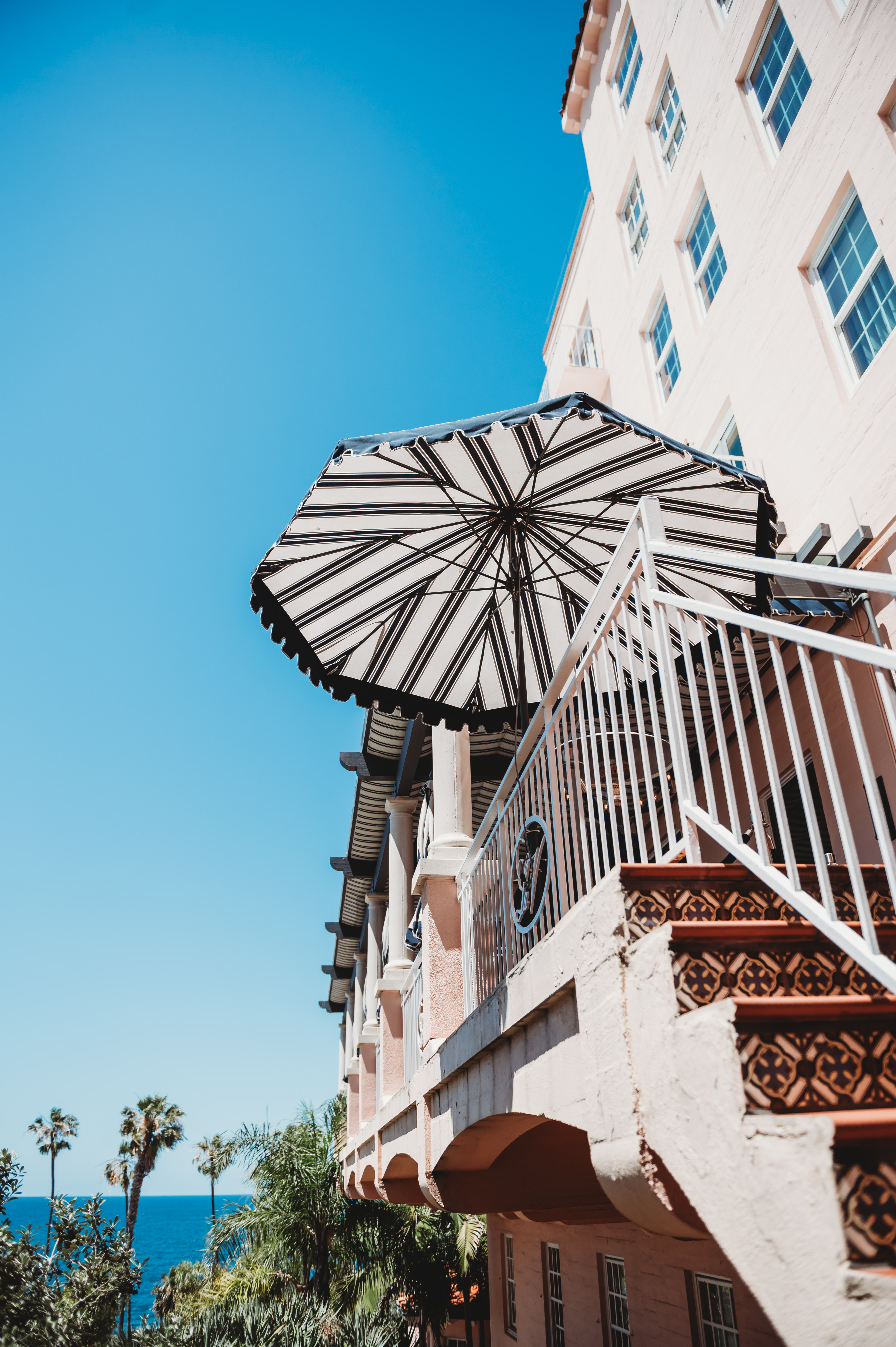 A striped terrace umbrella at La Valencia overlooking the Pacific