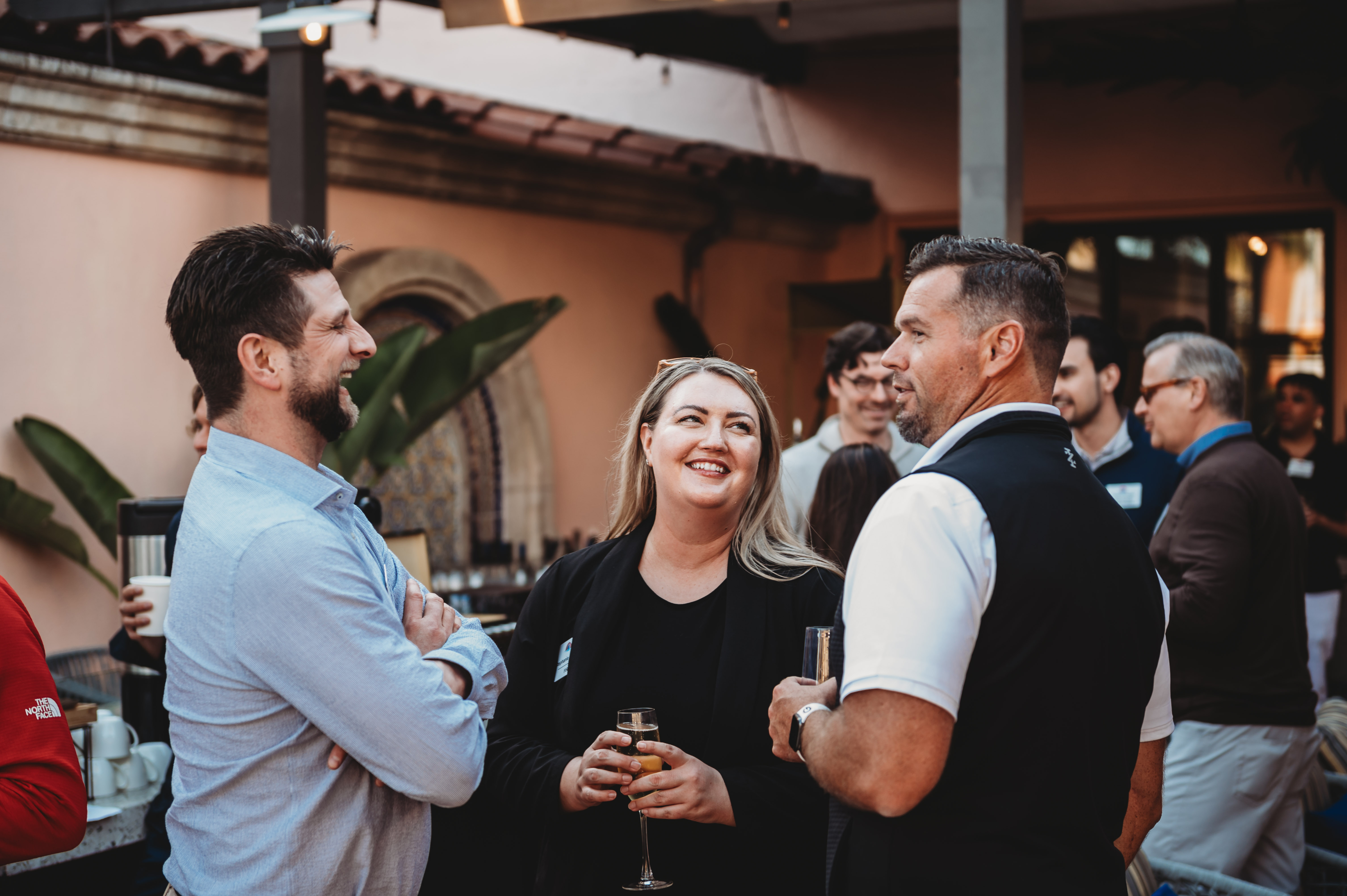 Three FIRE Summit 2026 attendees talking on the terrace