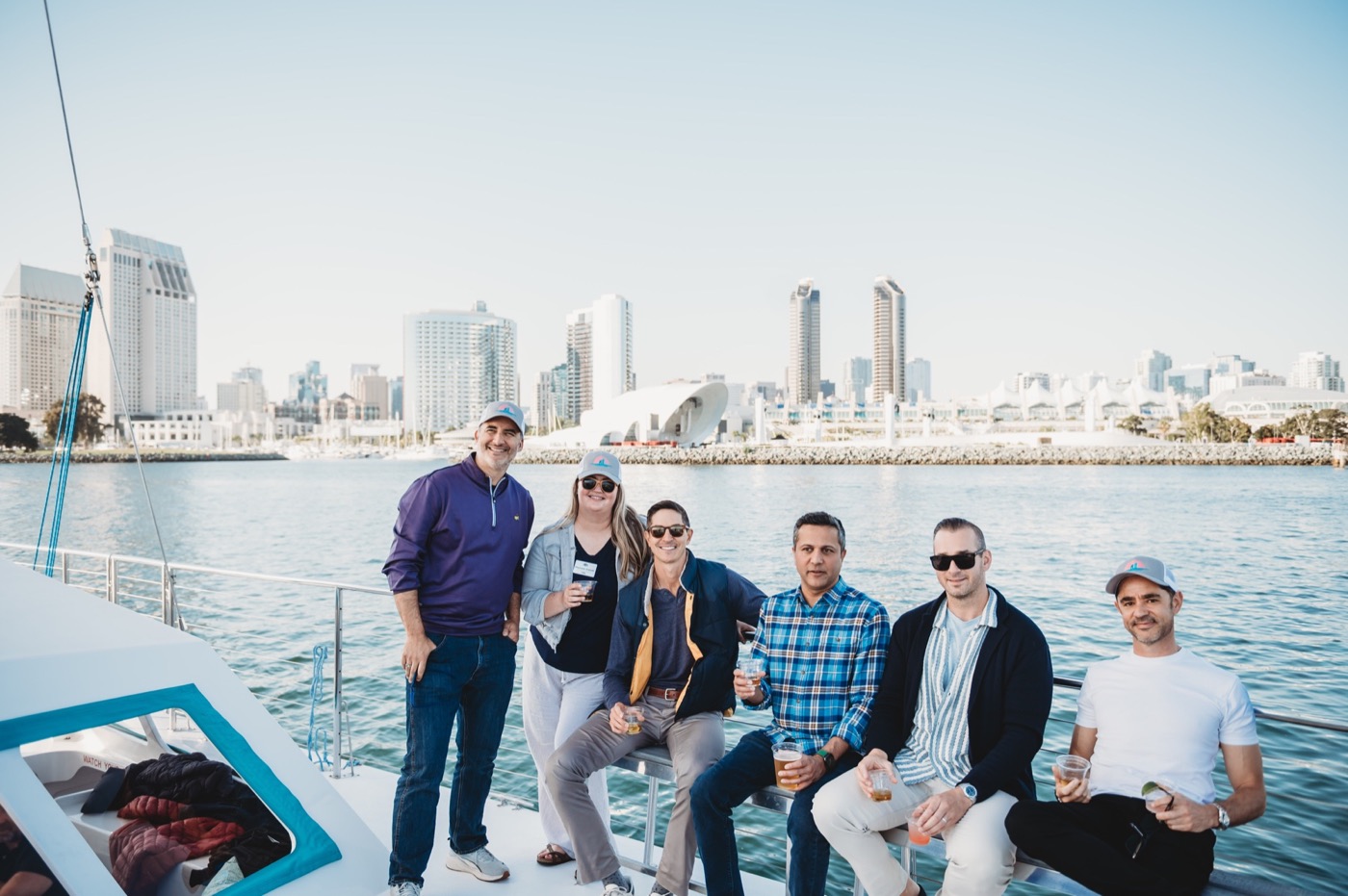 FIRE Summit 2026 attendees aboard the boat with the San Diego skyline
